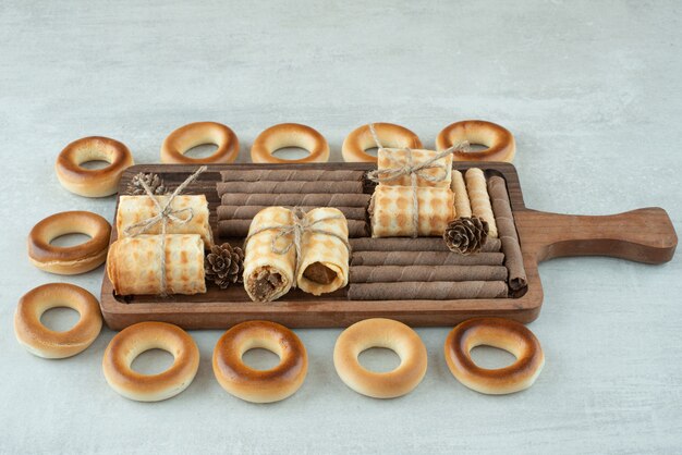 A wooden plate of round cookies on white background. High quality photo