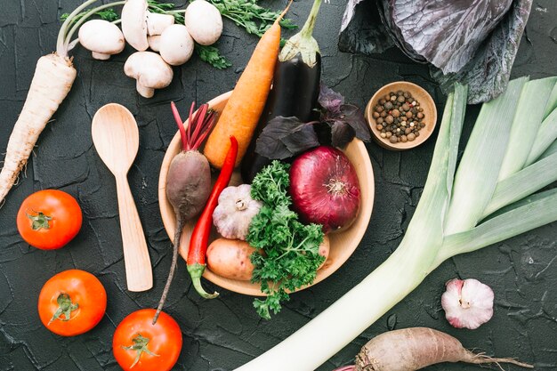 Wooden plate with ripe vegetables assortment