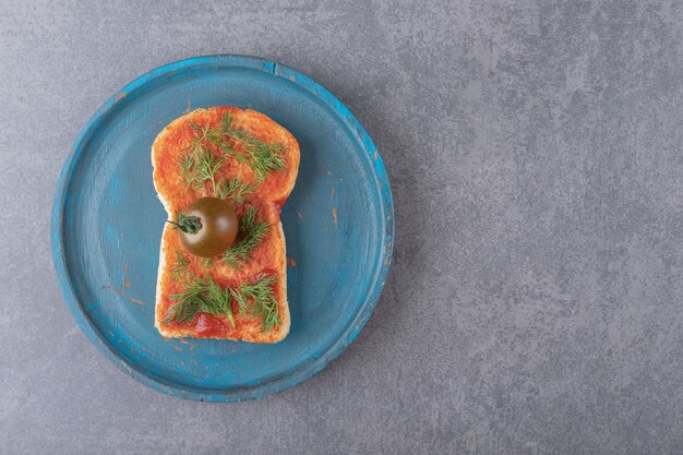 A wooden plate with toast on a marble surface