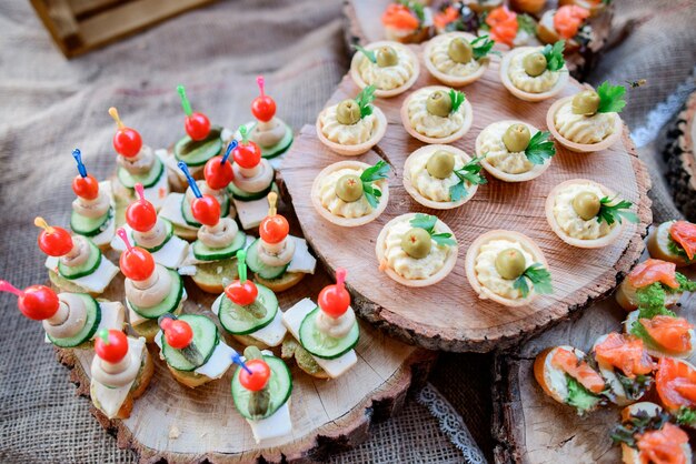 Wooden plates served with snacks of vegetables and cheese 