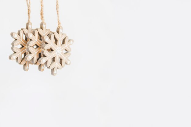 Wooden snowflake ornaments on white backdrop