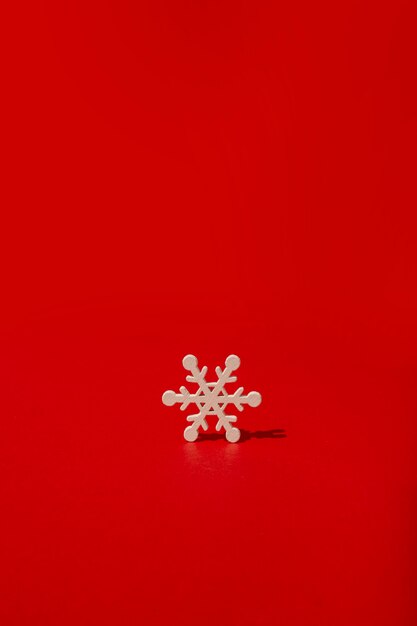 Wooden snowflake on red table