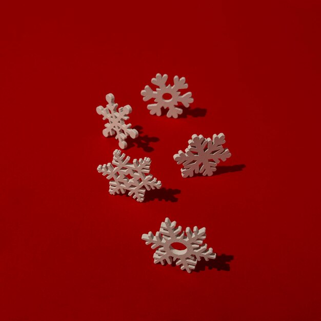 Wooden snowflakes on red table