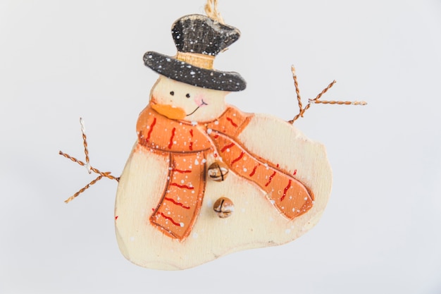 Wooden snowman ornaments on white background