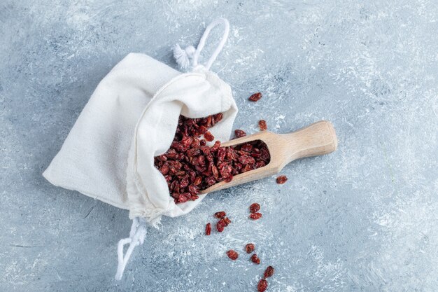 A wooden spoon full of dried cranberries. 