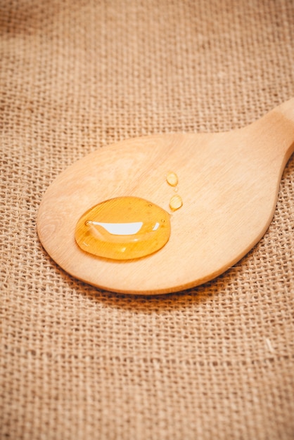 Wooden spoon with a drop of honey