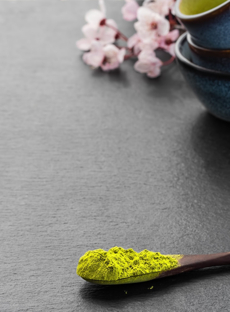 Free Photo wooden spoon with powdered matcha green tea