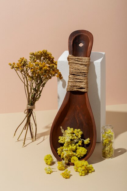 Wooden spoon with yellow herbs