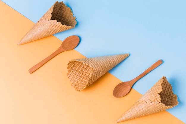 Wooden spoons and ice cream cones on table