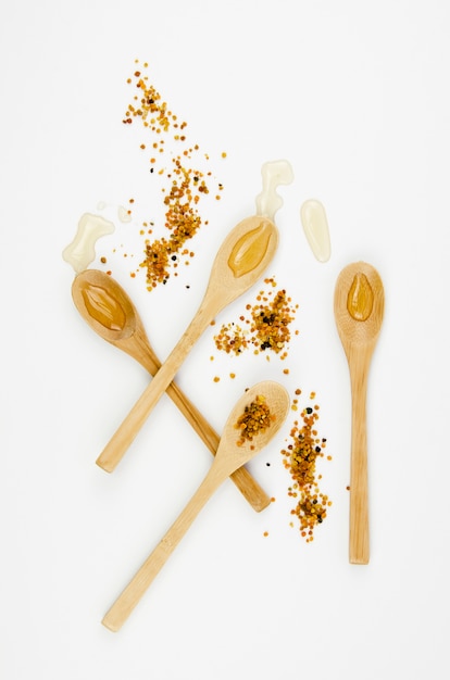 Wooden spoons with honey top view