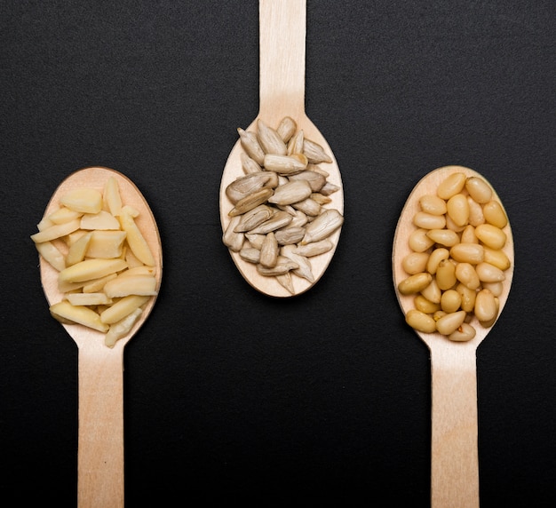Wooden spoons with seeds and spices