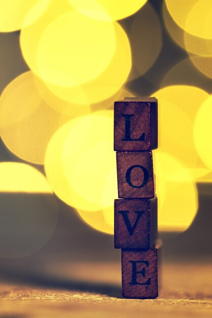 Wooden sticks with the word "love" and bokeh effect behind