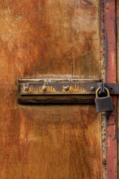 Wooden structure with rusty metal lock