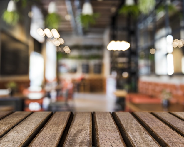 Wooden surface looking out to blurred restaurant