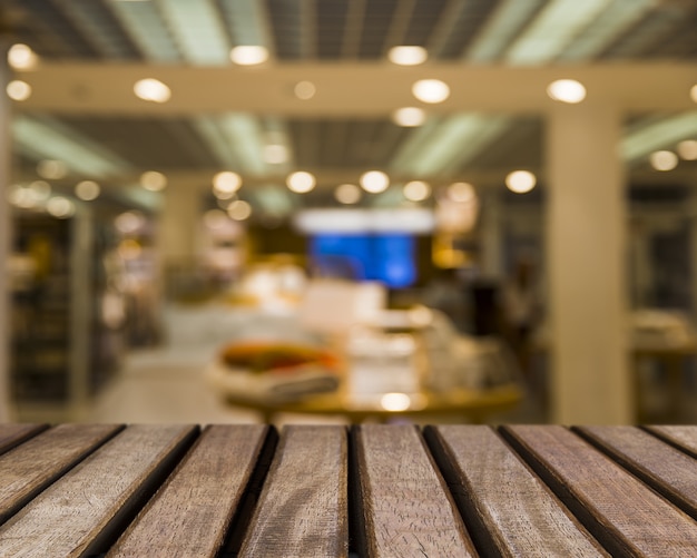 Wooden surface looking out to blurred shop