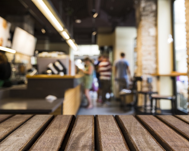 Wooden surface looking out to people in bar