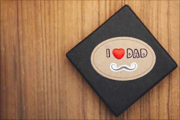 Free photo wooden surface with black box for father's day