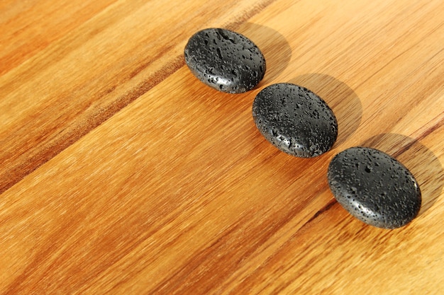 Free photo wooden surface with black lava beads in a spa salon - great for background or wallpaper