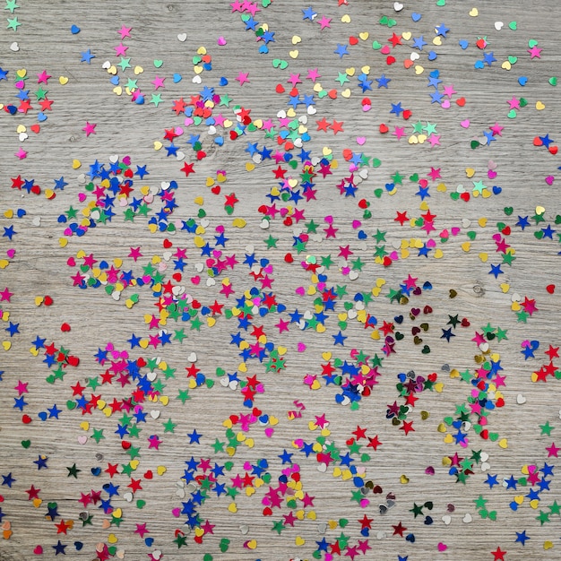 Wooden surface with colored confetti