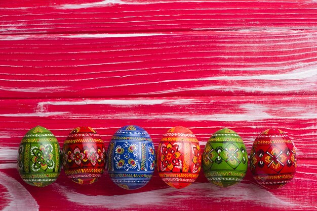 Wooden surface with decorative painted eggs for easter