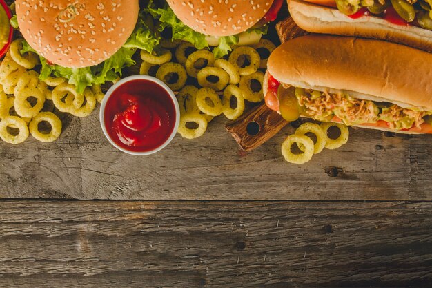 Wooden surface with delicious fast food