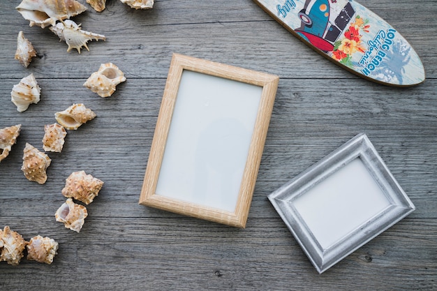 Free photo wooden surface with frames, surfboard and seashells