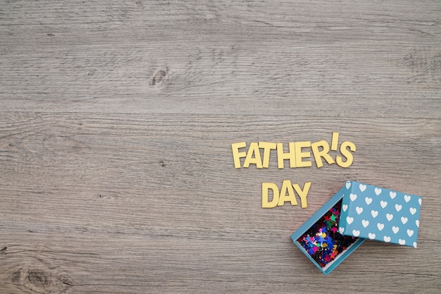 Wooden surface with gift box for father's day