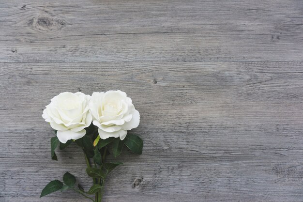  wooden surface with two pretty flowers