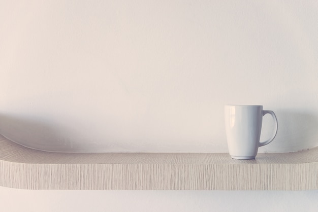 Wooden surface with a white cup