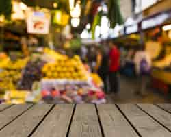 Free photo wooden table looking out to fruit market