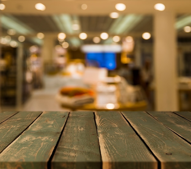 Free photo wooden table with blurred restaurant scene