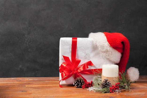 The wooden table with Christmas decorations and gift box