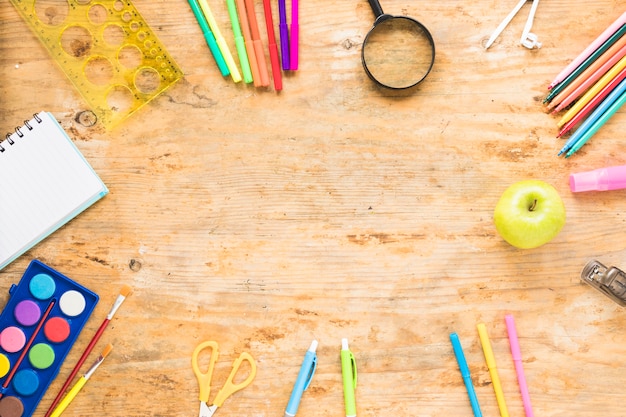 Wooden table with colorful drawing objects around