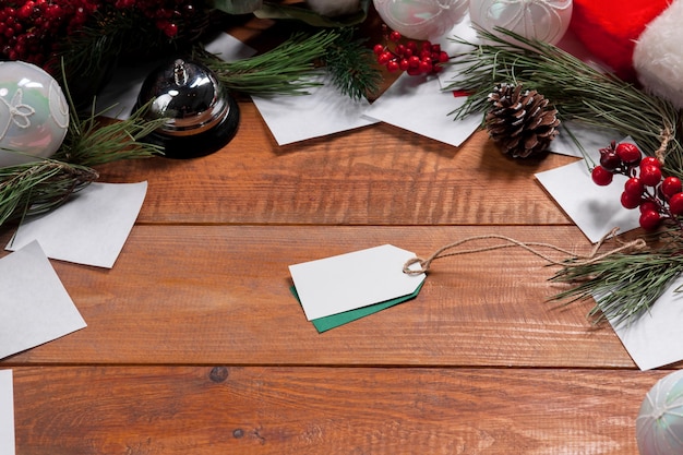 The wooden table with a empty  blank price tag and Christmas decorations.