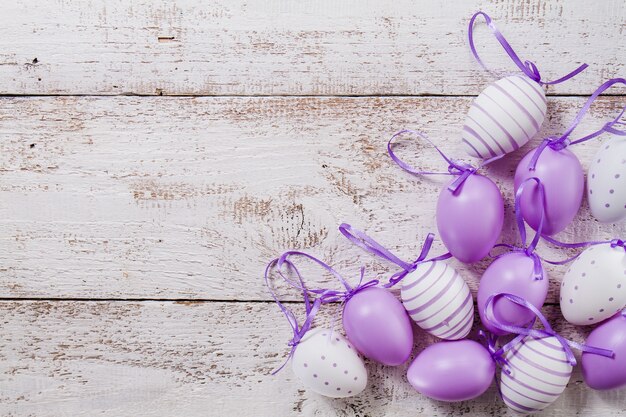 Wooden table with purple easter eggs