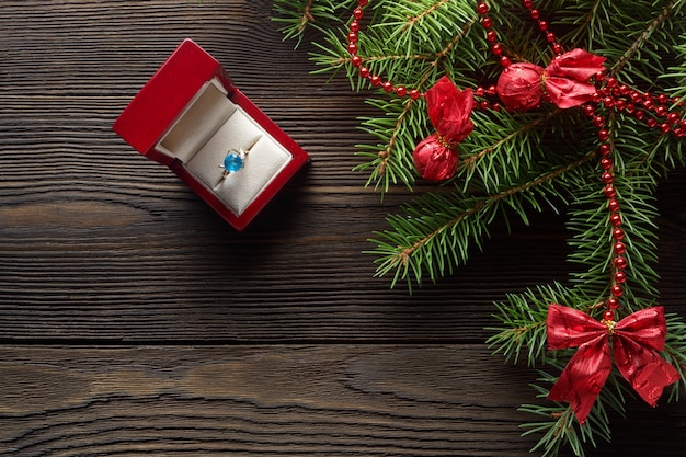 Wooden table with a red box with a ring