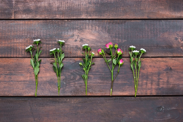 wooden table with roses, top view