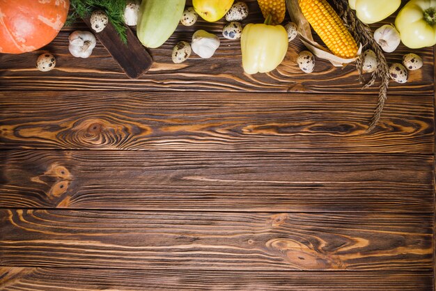 Wooden table with vegetables on top