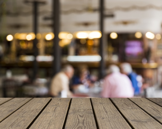 Wooden texture looking out to people in restaurant