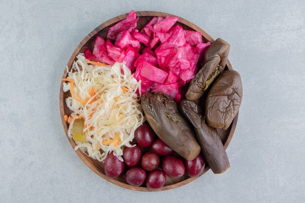 Wooden tray full of pickles    