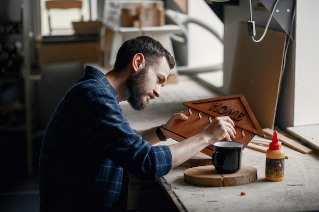 Free photo woodworker applying glue to coards