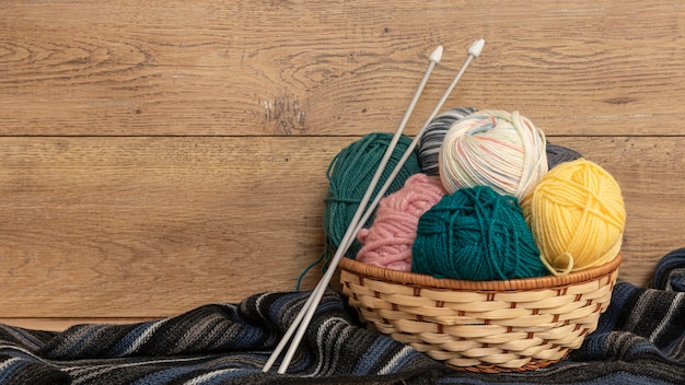 Wool and knitting needles in basket