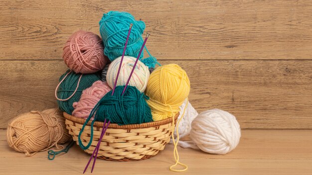 Wool and knitting needles in basket