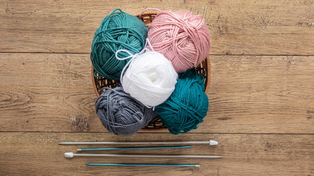 Wool and knitting needles in basket