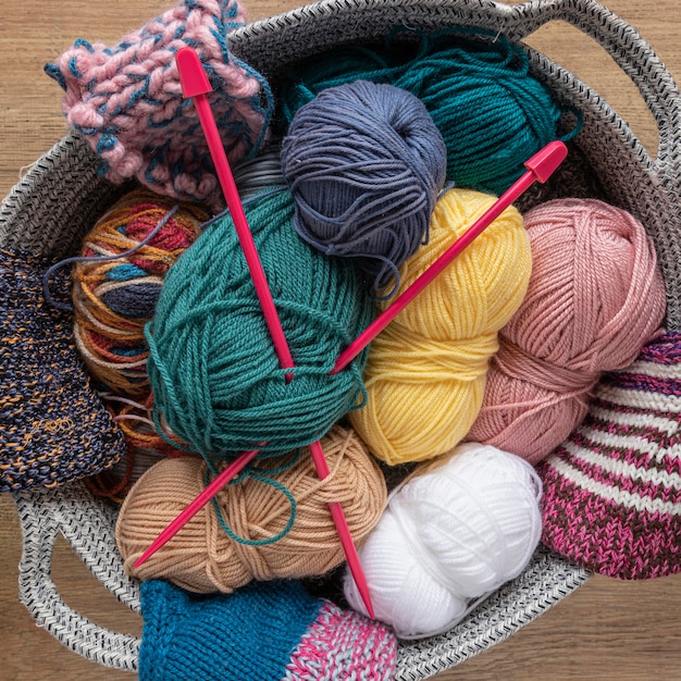 Wool and knitting needles in basket