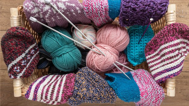 Wool and knitting needles in basket