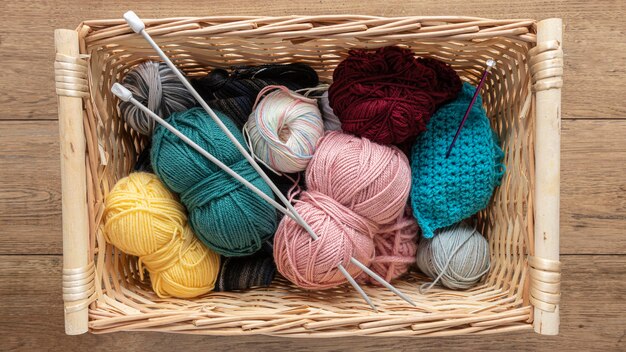 Wool and knitting needles in basket