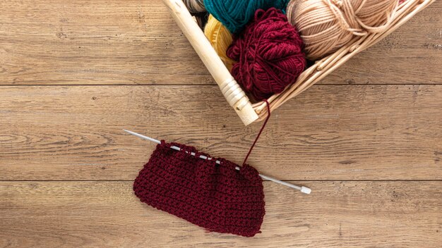 Wool and knitting needles in basket
