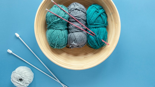 Wool and knitting needles in basket