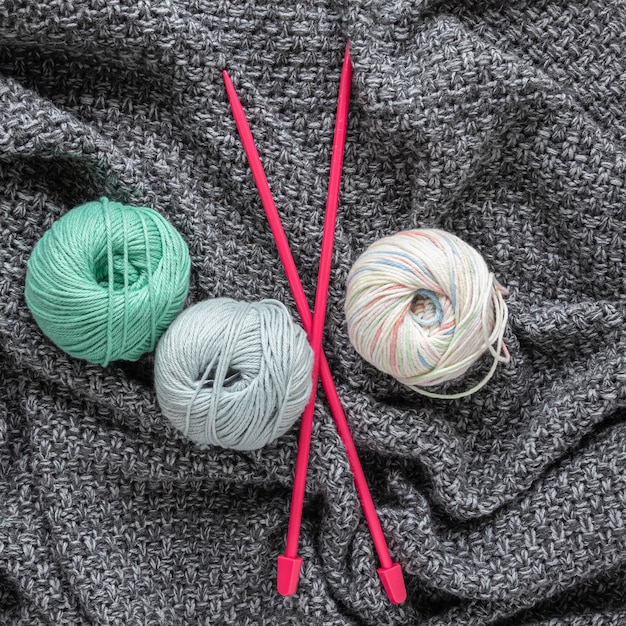 Wool and knitting needles close up